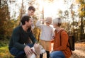 Beautiful young family with small children on a walk in autumn forest. Royalty Free Stock Photo