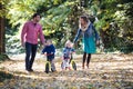 Beautiful young family with small twins on a walk in autumn forest. Royalty Free Stock Photo