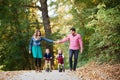 Beautiful young family with small twins on a walk in autumn forest. Royalty Free Stock Photo