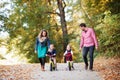 Beautiful young family with small twins on a walk in autumn forest. Royalty Free Stock Photo