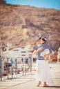 Beautiful young family of two walking along wooden jetty. Woman with son on pier Royalty Free Stock Photo