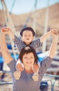 Beautiful young family of two walking along wooden jetty. Woman with son on pier Royalty Free Stock Photo