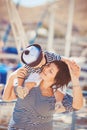 Beautiful young family of two walking along wooden jetty. Woman with son on pier Royalty Free Stock Photo