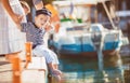 Beautiful young family of two walking along wooden jetty. Woman with son on pier Royalty Free Stock Photo