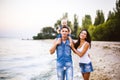 Beautiful young family on vacation with baby. The father holds the blonde girl in her arms, and the brunette`s mother hugs her hu Royalty Free Stock Photo