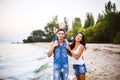 Beautiful young family on vacation with baby. The father holds the blonde girl in her arms, and the brunette`s mother hugs her hu Royalty Free Stock Photo