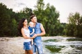 Beautiful young family on vacation with baby. The father holds the blonde girl in her arms, and the brunette`s mother hugs her hu Royalty Free Stock Photo