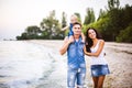 Beautiful young family on vacation with baby. The father holds the blonde girl in her arms, and the brunette`s mother hugs her hu Royalty Free Stock Photo