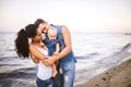 Beautiful young family on vacation with baby. The father holds the blonde girl in her arms, and the brunette`s mother hugs her hu Royalty Free Stock Photo