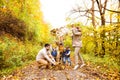 Beautiful young family on a walk in autumn forest. Royalty Free Stock Photo