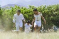 Beautiful young family on a walk in summer forest Royalty Free Stock Photo