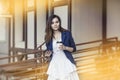 Beautiful young fashion gir with take-away coffee in hand and sm Royalty Free Stock Photo