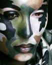 Beautiful young fashion woman with military style clothing and face paint make-up, khaki colored Royalty Free Stock Photo