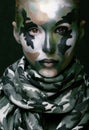 Beautiful young fashion woman with military style clothing and face paint make-up Royalty Free Stock Photo