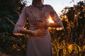 Beautiful young fashionable woman in dress on the field at sunset Royalty Free Stock Photo