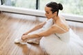 Beautiful young female ballet dancer relaxing after rehearsal. Royalty Free Stock Photo