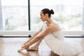 Beautiful young female ballet dancer relaxing after rehearsal. Royalty Free Stock Photo