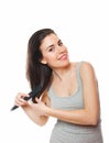 Beautiful young female combing her hair Royalty Free Stock Photo