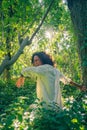 Beautiful young female with curly hair dancing in a park and laughing Royalty Free Stock Photo