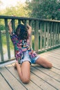 Beautiful young female dancing on a bridge in a park Royalty Free Stock Photo