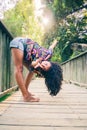 Beautiful young female dancing on a bridge in a park Royalty Free Stock Photo