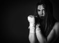 Beautiful young female fighter after the fight on a dark background. girls in martial arts. black and white. free space Royalty Free Stock Photo