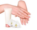Beautiful young female hands with a cream and orchids. Royalty Free Stock Photo