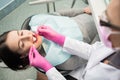 Beautiful young female having dental check up in dental office. Dentist examining a patient`s teeth Royalty Free Stock Photo