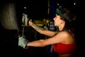 Beautiful young female mechanic inspecting car in auto repair shop. mechanic Royalty Free Stock Photo
