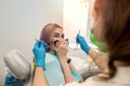 young female patient sits dentist closes her mouth from female dentist because she is afraid.