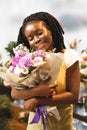 Beautiful young female person embracing unordinary bouquet