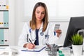Female pharmacis writing notes with boxes of medicine in Hand Royalty Free Stock Photo