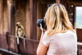 Beautiful girl takes picture of monkey in India