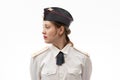 A beautiful young female Russian police officer in dress uniform in a cap and shoulder straps of a lieutenant colonel and a white