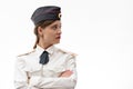 A beautiful young female Russian police officer in dress uniform in a cap and shoulder straps of a lieutenant colonel and a white