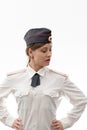 A beautiful young female Russian police officer in dress uniform in a cap and shoulder straps of a lieutenant colonel and a white