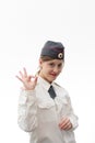 Beautiful young female Russian police officer in dress uniform shows hand signs perfectly and smiles on a white background Royalty Free Stock Photo