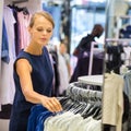 Beautiful young female shopper in a clothing store Royalty Free Stock Photo