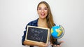 Beautiful young female student holding globe and blackboard with written back to school Royalty Free Stock Photo