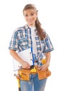 Beautiful young female worker with construction tools holding cl Royalty Free Stock Photo