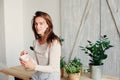 Beautiful young feminine woman relaxing at home in lazy weekend morning with cup of coffee