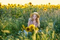 Beautiful young on the field of sunflowers