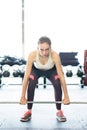 Beautiful young fit woman in gym lifting heavy barbell Royalty Free Stock Photo