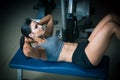 Beautiful young fit woman workout abdominal muscles abs in fitness gym Royalty Free Stock Photo