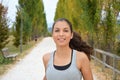 Beautiful young fitness woman running in the park. Smiling girl training outdoors Royalty Free Stock Photo