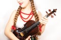 A beautiful young folk woman holding a violin Royalty Free Stock Photo