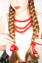 A beautiful young folk woman presents her long tresses Royalty Free Stock Photo