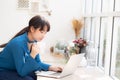 Beautiful young freelance asian woman smiling working and on laptop computer at desk coffee shop with professional Royalty Free Stock Photo