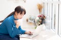 Beautiful young freelance asian woman smiling working and on laptop computer at desk coffee shop with professional Royalty Free Stock Photo