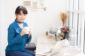 Beautiful young freelance asian woman smiling working and on laptop computer at desk coffee shop with professional Royalty Free Stock Photo